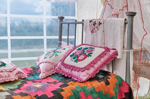 Preview: Traditional decor of bed in Tatar vintage style. Woven bedspread, pillows embroidered with ribbons