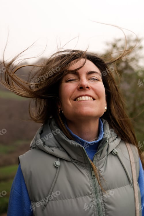 Preview: Happy young woman feeling wind in her face. Freedom concept.