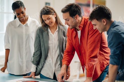 Preview: Marketing team analyzing pie chart during business meeting