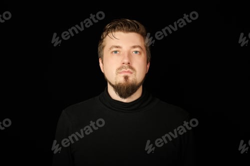 Preview: Cute bearded young guy in black polo neck sweater.