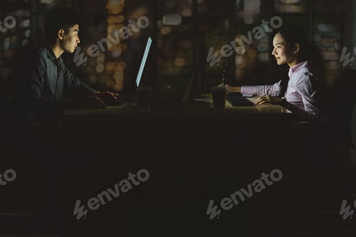Preview: Asian business woman and business man working hard late together with technology computer in office