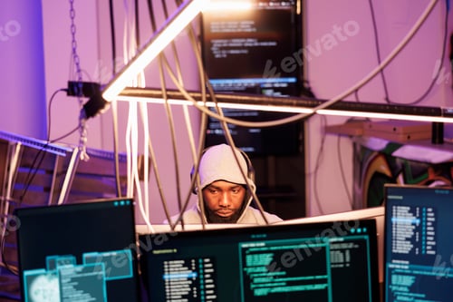 Preview: Hacker in headphones programming malware