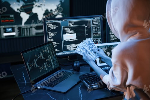 Preview: Young professional female hacker is indoors by computer with lot of information on displays