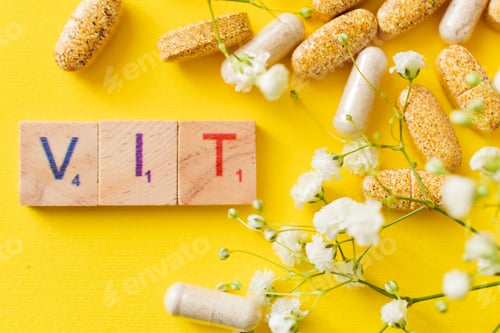 Preview: Pills and vitamins on yellow background