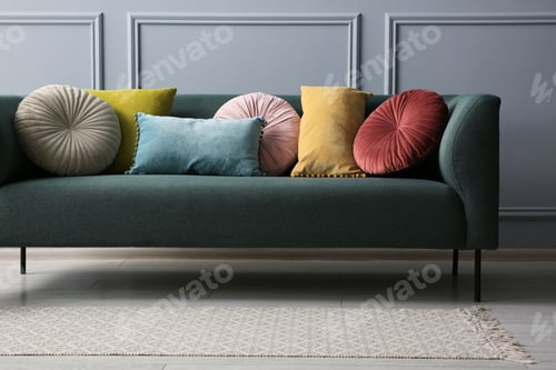 Preview: Stylish sofa with different cushions near grey wall