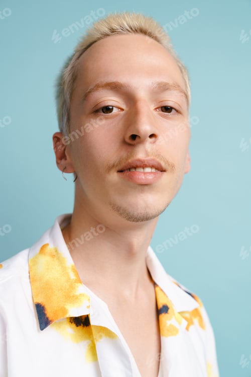 Preview: Young blonde man in shirt posing and looking at camera