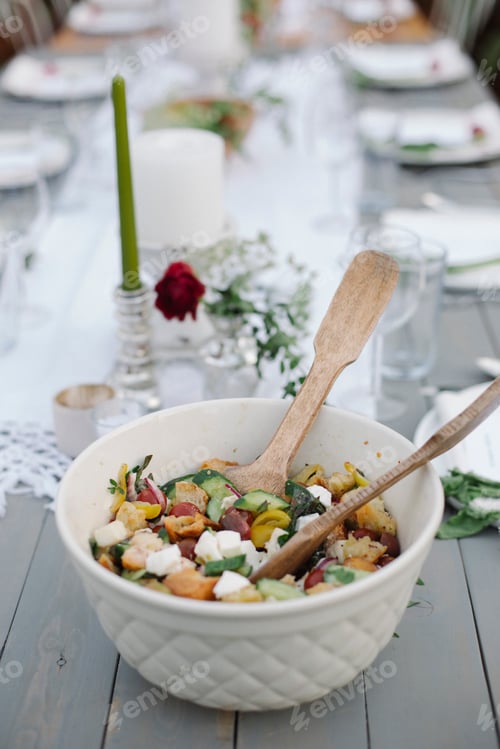 Preview: A bowl of salad on a table in a garden.