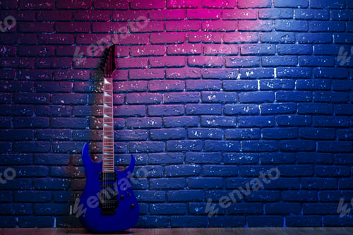 Preview: Electric guitar in neon light against dark walll