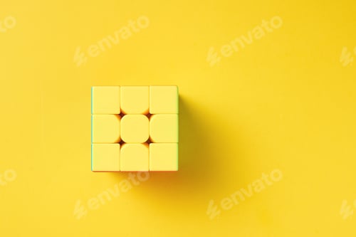Preview: Dobrush, Belarus - 3 February 2019. Rubics cube on a yellow background, top view