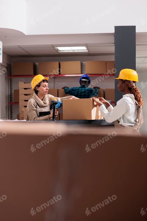 Preview: Storehouse workers using box sealing tape for packing parcel