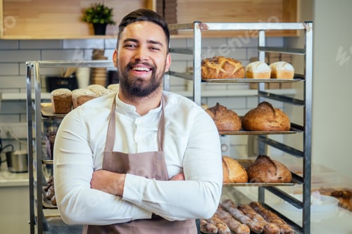 Preview: Handsome baker in uniform at the manufacturing small business owner concept