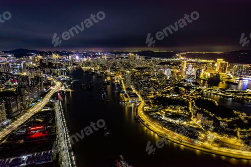 Preview: Aerial shot of a night city with lights, a river and tall buildings