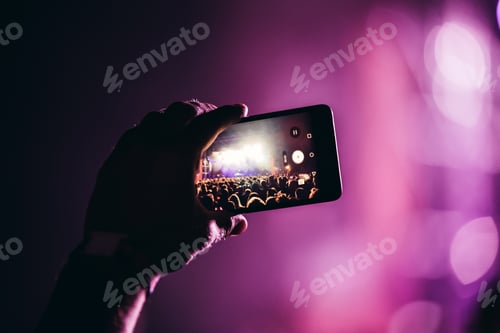 Preview: Close-up picture of person holding camera on music festival
