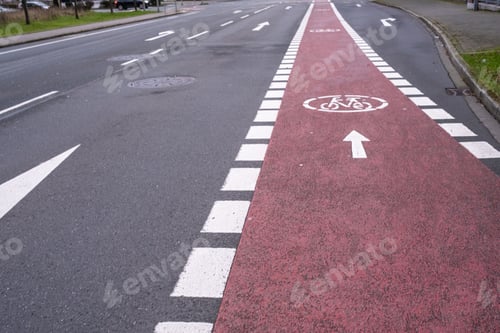 Preview: Brightly painted bike lane on a city street, with a white arrow pointing in the direction of travel