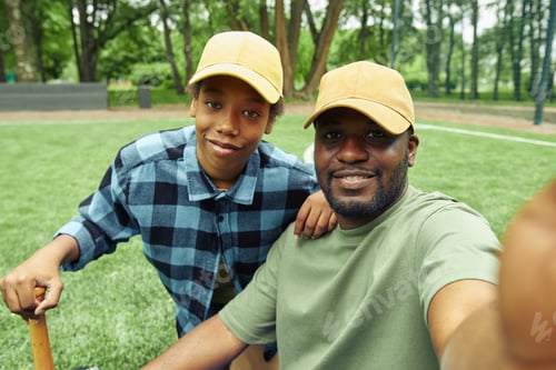 Preview: Selfie portrait of dad and son on baseball field