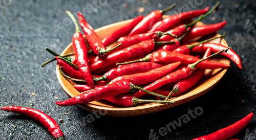 Preview: Chili peppers on a wooden plate.