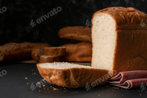 Preview: freshly baked sliced white bread with metal knife, toasts for cooking sandwitchs
