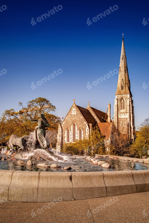 Preview: historical statue and fountain near beautiful church in copenhagen, denmark