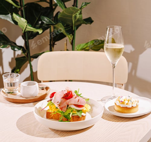 Preview: A brunch table features a colorful open-faced sandwich topped with greens and ham