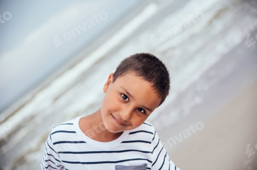 Preview: summer vacation at sea. Boy at seaside. Close up portrait of Child on beach