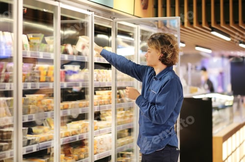 Preview: Man Choosing Frozen Food From A Supermarket Freezer