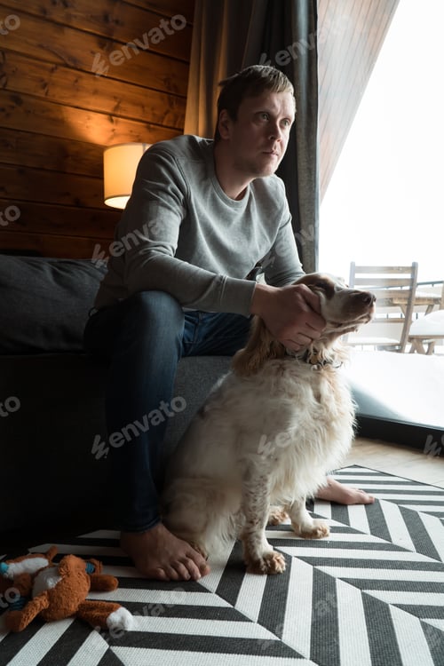 Preview: Man with Dog Sitting in Rustic Home