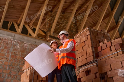 Preview: Contractor demonstrating architectural drawings for