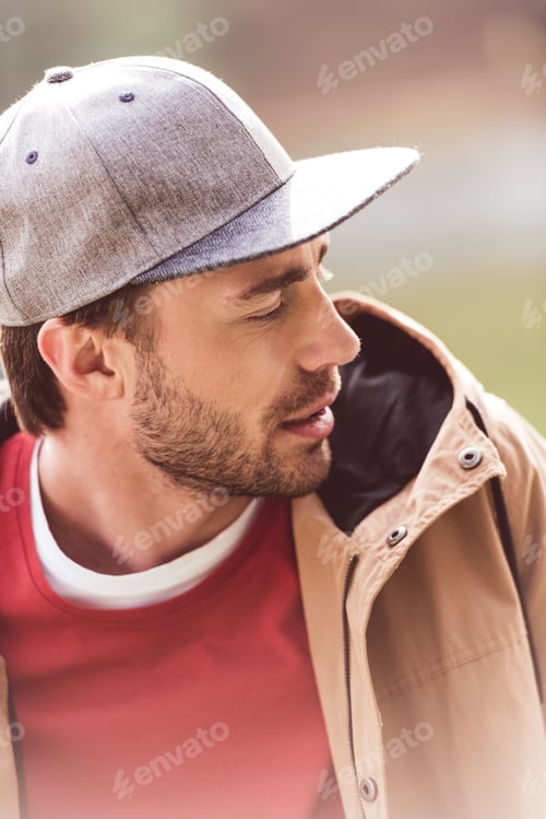 Preview: Close-up portrait of young bearded man traveler looking away