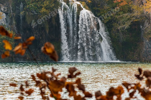 Preview: Autumn shot of a waterfall flowing down into a lake in Plitvice Lakes national park
