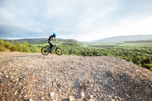 Preview: Cyclist riding on the rocky mountains