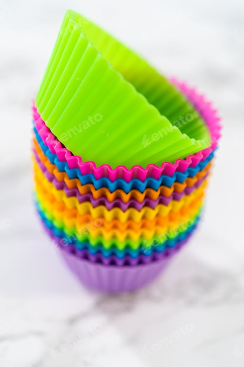 Preview: Colorful Silicone Cupcake Liners Stacked on White Surface