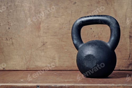 Black Kettlebell on Brown Wooden Surface