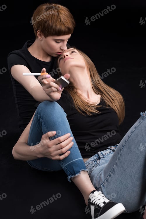 Preview: Half-length shot of young lesbian couple embracing and looking at each other