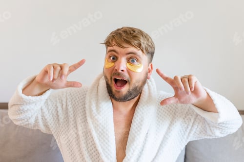 Preview: Beauty treatments, skin care, metrosexual concept. A handsome bearded man with golden bandages under