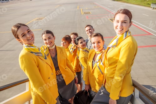 Preview: Smiling Flight Attendants Stand on Airplane Stairway