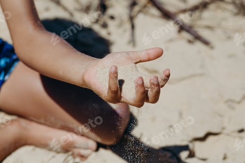 Preview: Black child playing with sand