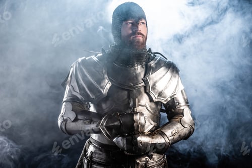 Preview: handsome knight in armor looking away on black background