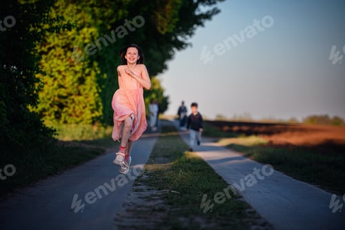 Preview: Joyful Girl Running on Country Path at Sunset