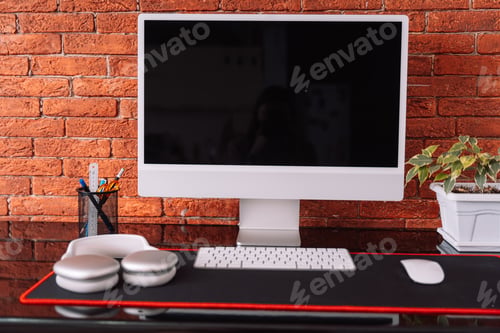 Preview: Cozy workplace with computer and wireless devices and home plant