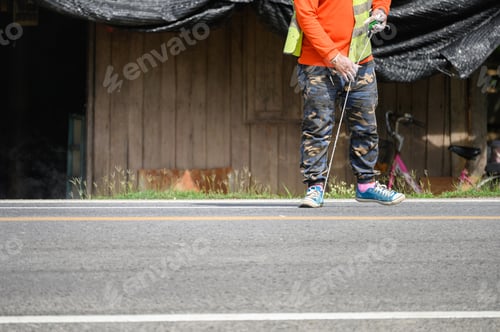 Preview: Worker wearing uniform is striping with measuring on the road