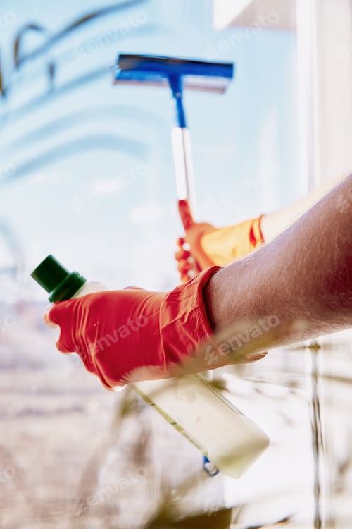 Preview: Spring cleaning concept. Man is washing windows. Household chores