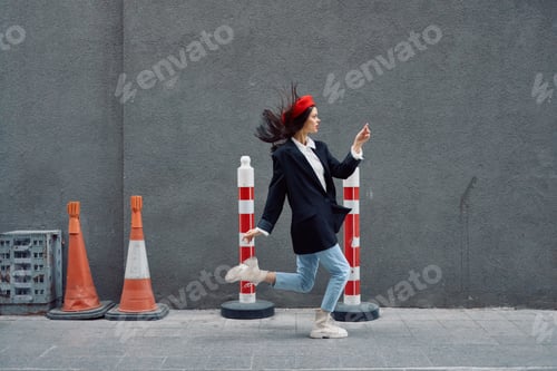 Preview: Fashion woman running down the street in front of the city tourist in stylish clothes with red lips