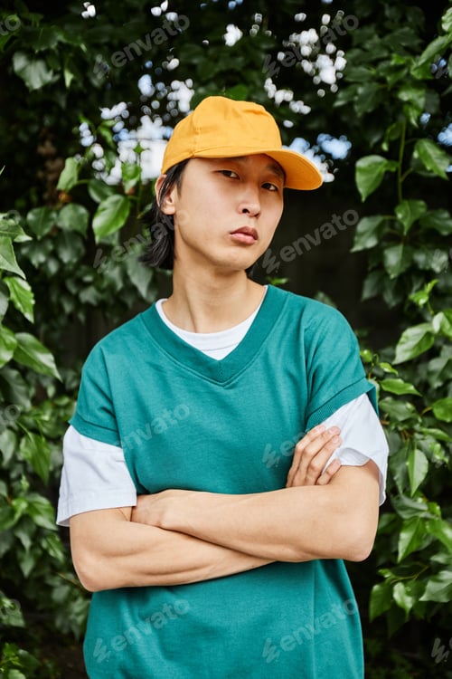 Preview: Asian man wearing colorful casual wear posing outdoors