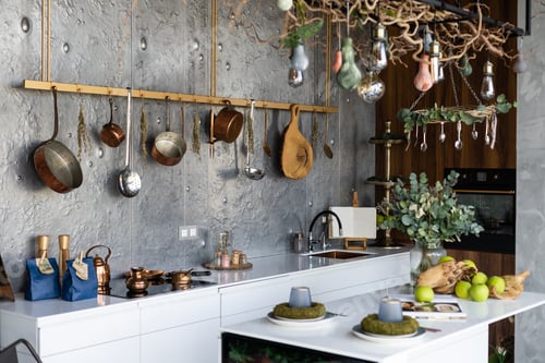Preview: Set of saucepans hanging in kitchen. Hanging Copper kitchen utensil on the white wall. Different