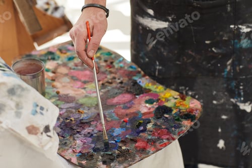 Preview: Unrecognizable Man Mixing Paint on Palette