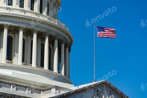 Preview: Low angle closeup of The United States Capitol under the sunlight and a blue sky in Washington DC