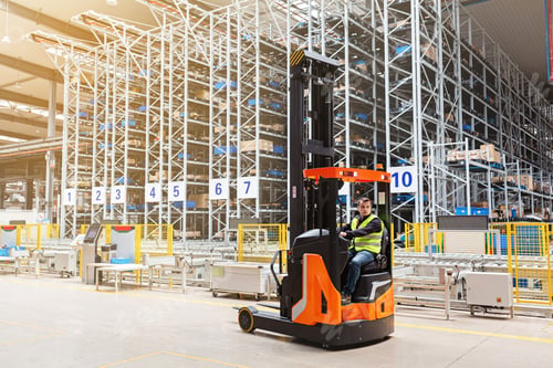 Preview: Employee working on forklift in modern automatic warehouse. Industrial Mockup with copy space