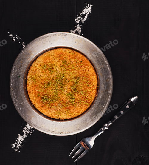 Preview: Traditional turkish dessert kunefe knefe serving on dark rustic table