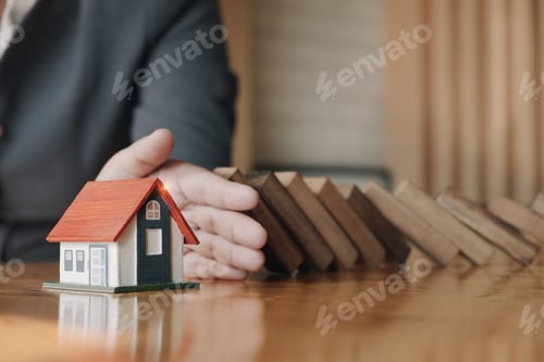 Preview: Business risk control Real estate concept, Businessman protect wooden block fall to planning and