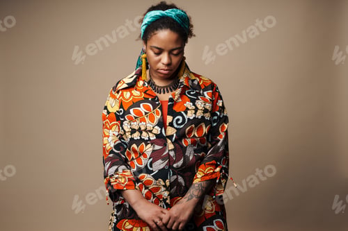Preview: Young black woman in headband posing and looking downward